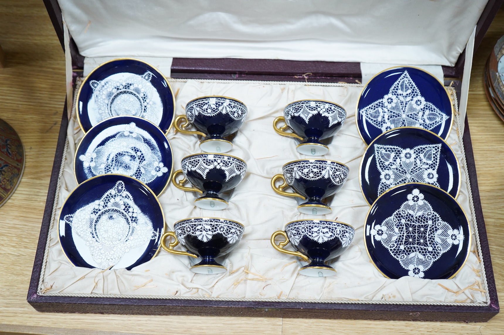 A Vienna-style lace-pattern coffee set, Beehive marks, cased